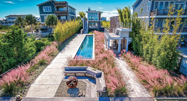 Few plants would be able to withstand the oceanfront weather and climate, so Walton favored planting large quantities of only a few species. He says the muhly grass is one of his favorites for the pink and purple color it adds.