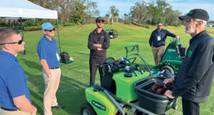 Turfco’s John Kinkead (left), George Kinkead (second from left) and Brad Hendrickson (second from right) show off the new T3200 spreader/sprayer with Alex and Scott Lawn. (Photo: LM staff)