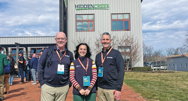 Inside the ropes: During a tour of Hidden Creek Landscaping at GROW! 2025 in Columbus, Ohio, LM’s Scott Hollister (left) and Bill Roddy (right) connected with Dara Dolinsky of Team Engine. (Photo: LM staff)