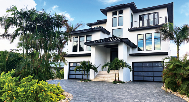 The new landscaping included plantings such as royal and coconut palms, clusia hedges, blue daze and other salt-resistant options. Lee says the tall vegetation helps with privacy. (Photo: Landscapes by Randy Lee)