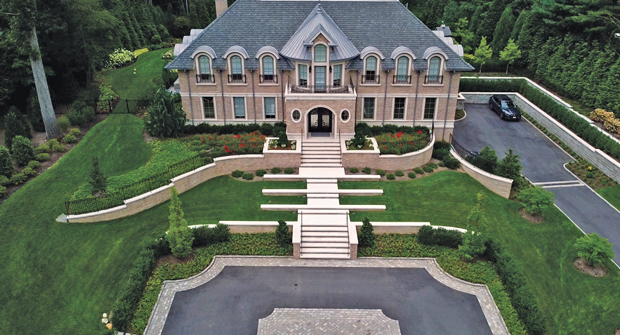The design of the house is a nod to classic estates, and Haugsjaa says the company still does weekly maintenance with mowing, plant health care, seasonal color, pruning and/or other tasks. (Photo: Rachel Bires and Goldberg and Rodler, Inc.)