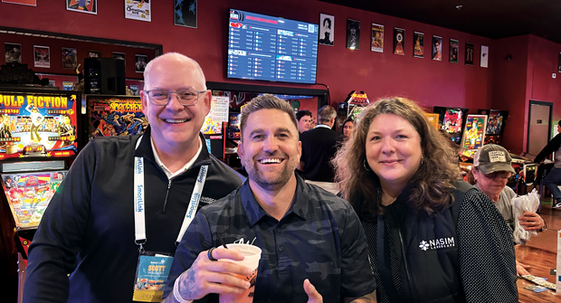Barcade bonding: At Weathermatic’s SmartCon 2025 event, Justin White with K&D Landscaping (center) hosted a reception for his new online community, The Disruptors. He’s pictured here with Hollister and Colleen Parris from Nasim Landscaping. (Photo: LM staff)