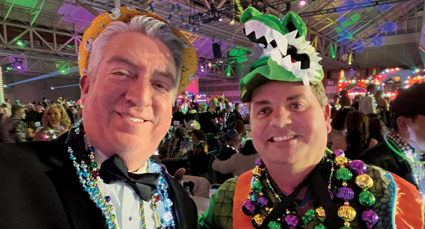 Go Gators! Jones and James Cali, principal, McFarlin Stanford. Cali has been riding on the “Bacchagator” float for years. His job? To spread cheer and toss beads to the crowd while dressed as an alligator.