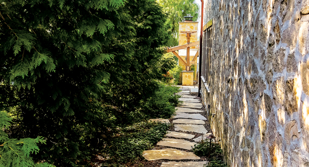 A pathway and other hardscapes complemented the backyard design, allowing the space to feel more inviting and practical. (Photo: David J. Frank Landscape Contracting)