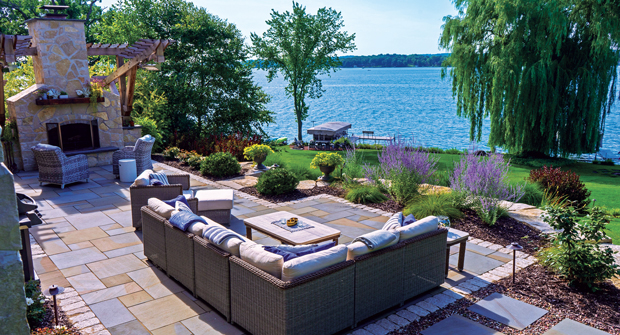 The stones from the existing patio were removed and broken into smaller pieces to use on walls in the front and back of the property, and some walls were built to raise the grade along the yard’s perimeter to dam water that came in from the neighbor’s paved surfaces. (Photo: David J. Frank Landscape Contracting)