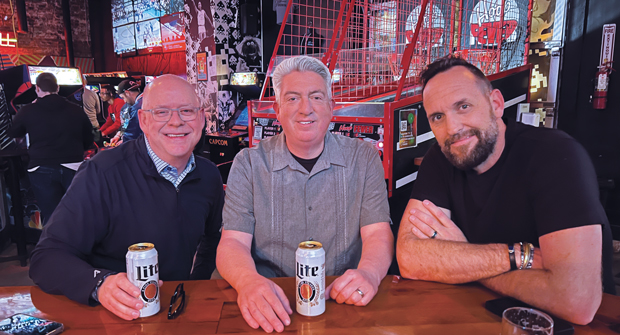 Turn back the clock: During a visit to Kansas City, Hollister and Jones met up with John Perry (right) with Greene County Fertilizer Co. to show off Up-Down, Kansas City’s vintage coin-operated arcade and bar. (Photo: LM staff)