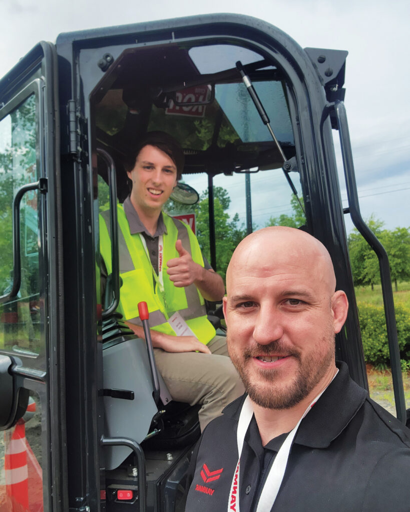 Excavator excellence: LM Associate Editor Nathan Mader got to use one of Yanmar’s excavators in the company’s Y.O.U. Club equipment challenge. Thanks to a little help from Zac Evans, product manager, Mader completed the task of using the machine to pick up and drop basketballs into buckets. (Photo: LM staff)