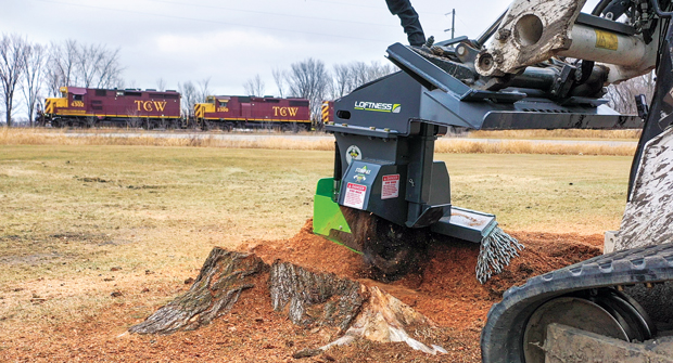 Safety First: Stump grinding attachments use guards over the wheels and deflectors to prevent debris from flying everywhere. (Photo: Loftness)