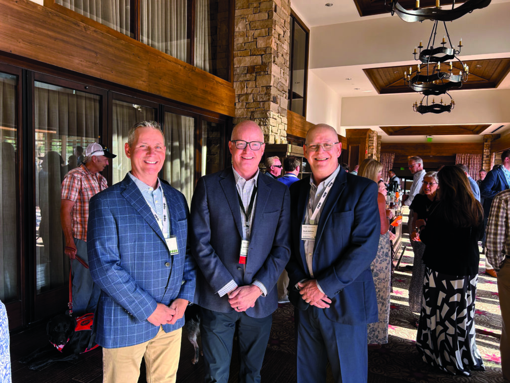 What a way to go: Just days before his official retirement, Roddy and Hollister shared a celebratory conversation with David Thorne (center), OPEI’s board chairman and, at that time, vice president, turf and compact utility business unit for Deere and Co. (Photo: LM staff)