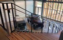 Vintage Davey Tree work trucks on display at the entrance, alongside a staircase made from repurposed, once unhealthy trees. (Photo: LM staff)