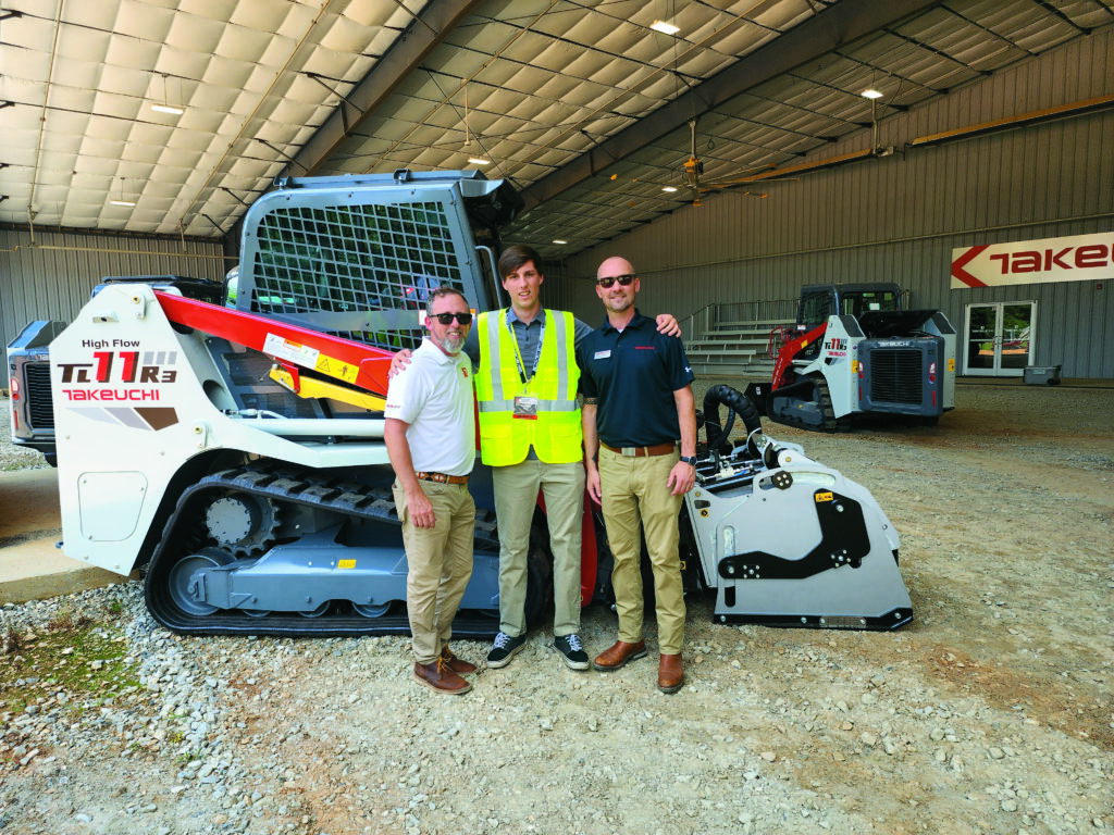 Big dogs: Takeuchi-US’ national marketing manager Stephen Odom (left) and national product manager Lee Padgett (right) posed with Mader in front of the company’s new TL11R3 compact track loader at Takeuchi’s Media Days event in Pendergrass, Ga. (Photo: LM staff)