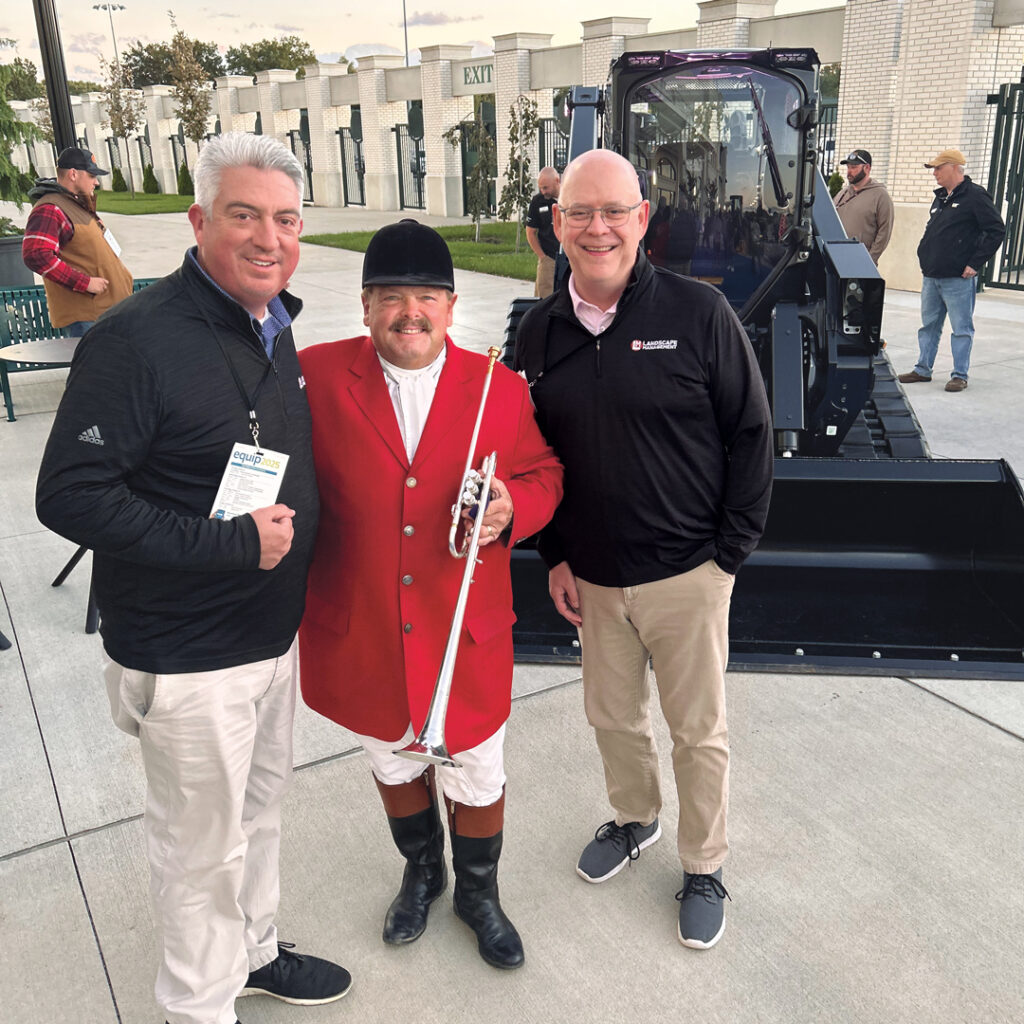 Off to the races: Jones and Hollister grabbed a quick photo with the official bugler of Churchill Downs, Steve Buttleman, before Equip Expo’s Welcome Reception inside the First Turn Club at the famed horse racing venue. (Photo: LM staff)