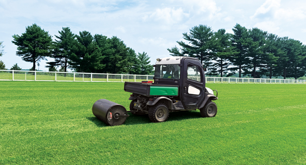 Rolling with a pull-behind sod roller is used to smooth the surface, close divots and maintain consistent footing after horse workouts. (Photo: Sport and Entertainment Corporation of Maryland)