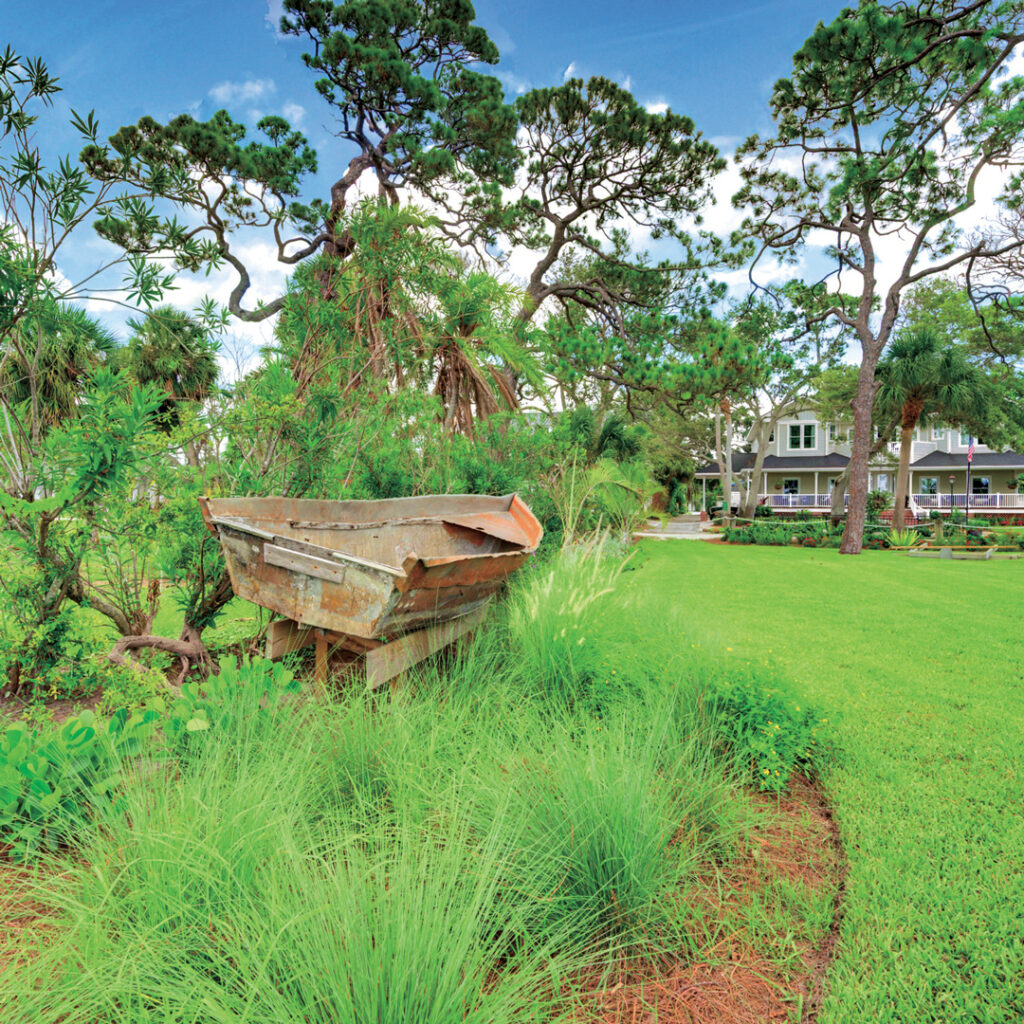 A historic boat that transported immigrants from Cuba and landed at the client’s previous Florida Keys home was transferred over to be a part of the new landscape design. (Photo: Landscapes by Randy Lee)