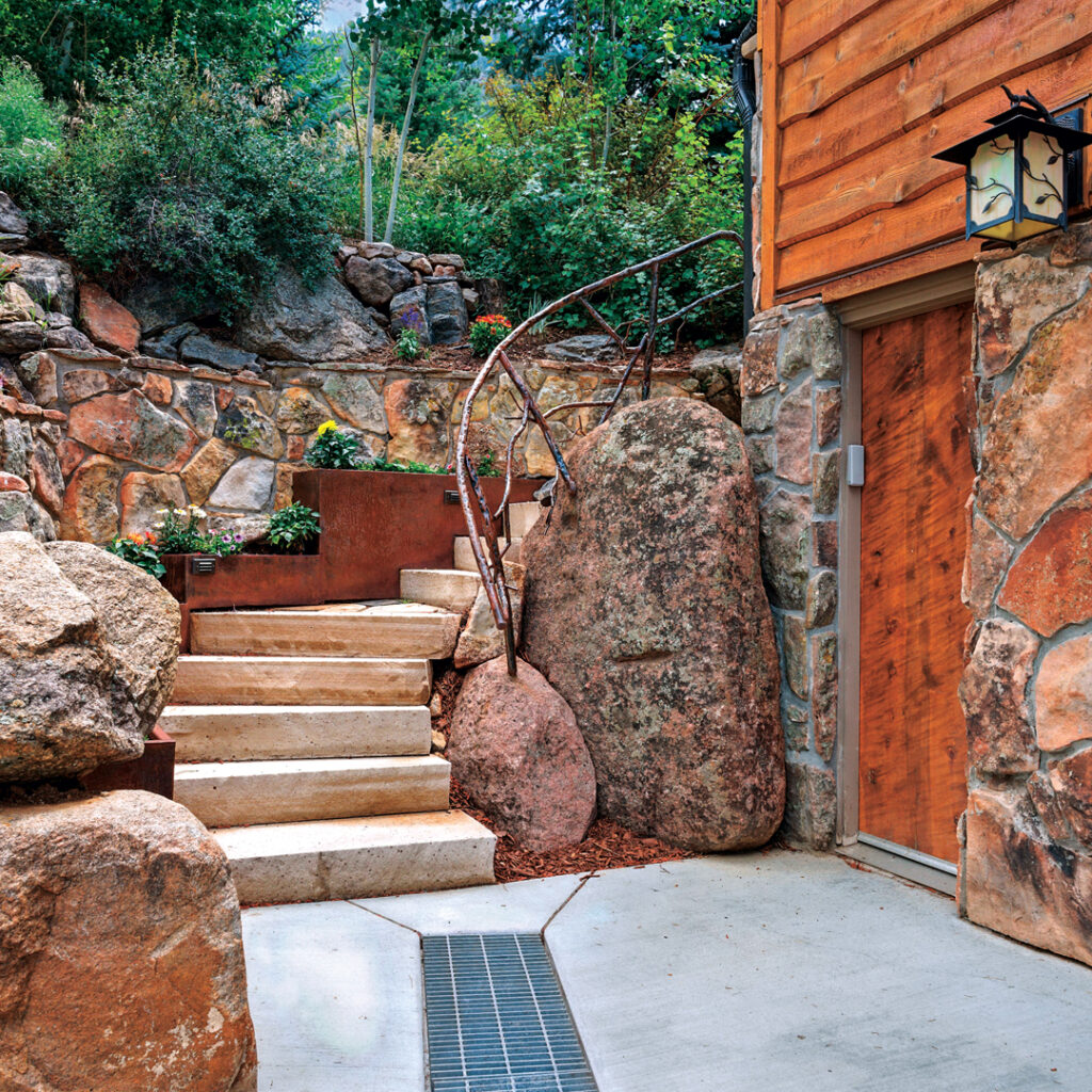 Noting that the flagstone patios and walkways spanning the backyard could become permanent barriers to repairs, the Alpine Gardens team implemented an extensive sleeving strategy, installing 3-inch and 6-inch conduits beneath all hardscape elements. (Photo: Alpine Gardens)