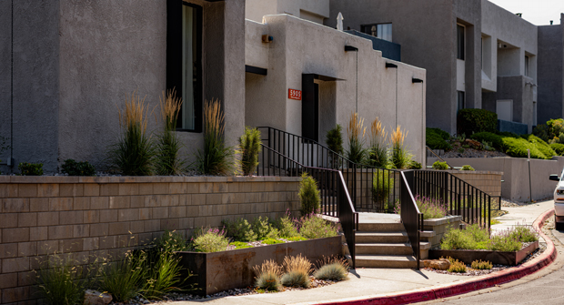 Grasses and perennials accent the walls and planters. The Melville wall and metal planters tie in nicely to the building’s stucco color and metal accents. (Photo: Brent Peterson with Antigravity Films, LLC)
