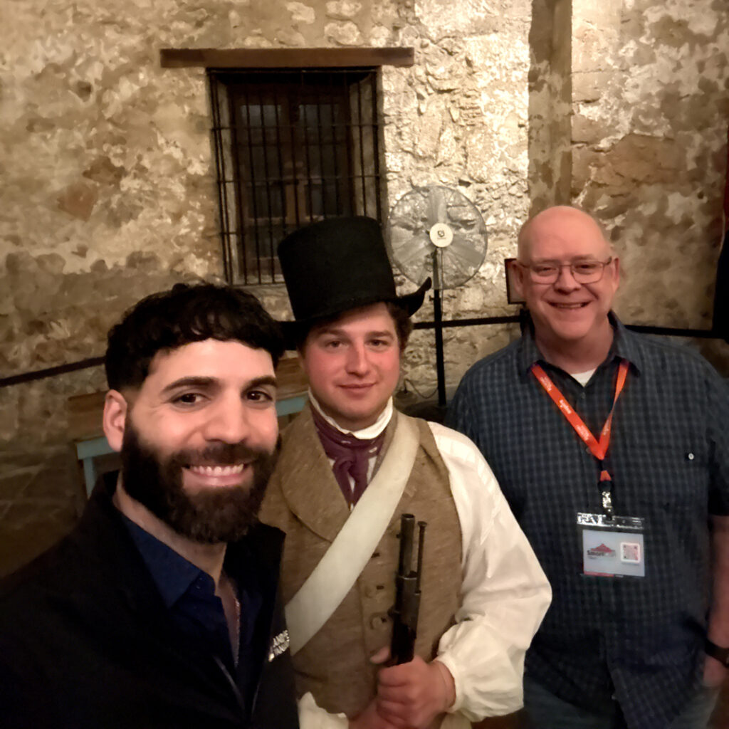 Texas trio: Hassen and Hollister commemorated a dinner and reception at The Alamo during SmartCon 2026 with this selfie with one of the volunteers. (Photo: LM staff)